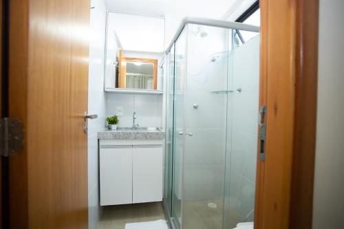 a bathroom with a sink and a glass shower at FLAT BOA VIAGEM PRÓXIMO A PRAIA in Recife