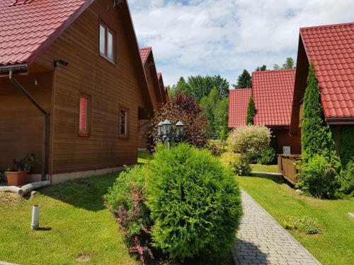 a row of houses with red roofs at Domki Nad Krystaliczną Zatoką in Polańczyk