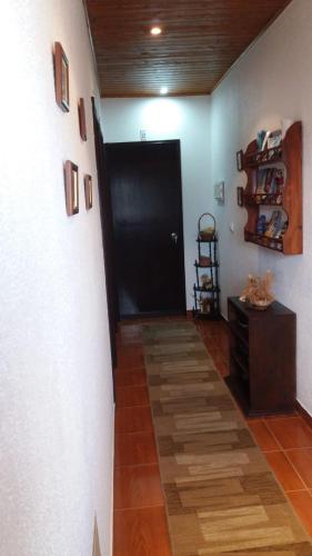 a hallway with a black door and a wooden floor at Country House Alfarim in Alfarim