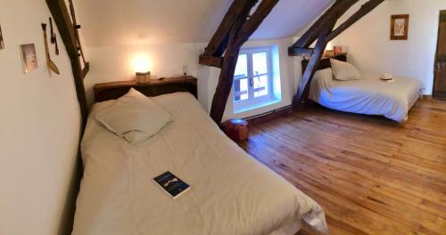 a bedroom with two beds and a window at La Cordillière in Laveraët