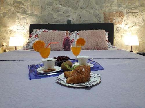 a tray of food on a bed with drinks and fruit at Apartment Karla SNB in Lozovac