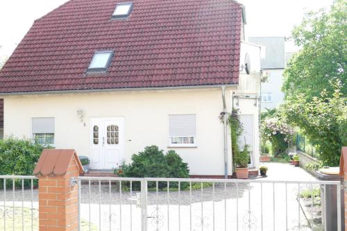 a white house with a red roof at 5 Gartenstraße in Angermünde