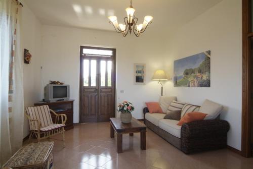 ein Wohnzimmer mit einem Sofa und einem TV in der Unterkunft The Sea View Mountain Apartment in Fasano