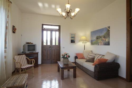 a living room with a couch and a tv at The Sea View Mountain Apartment in Fasano
