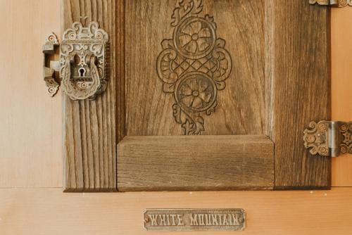 a wooden door with a sign that reads synergy minnesota at The Kitch'inn - Boutique Inn and Wine Bar in Mahone Bay