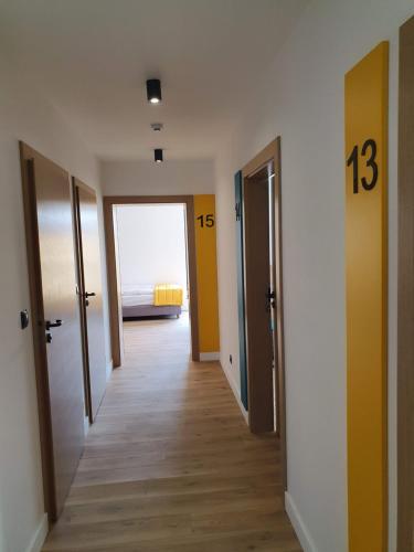a hallway with two doors and a room with a bed at VILLA 17 Noclegi in Płock