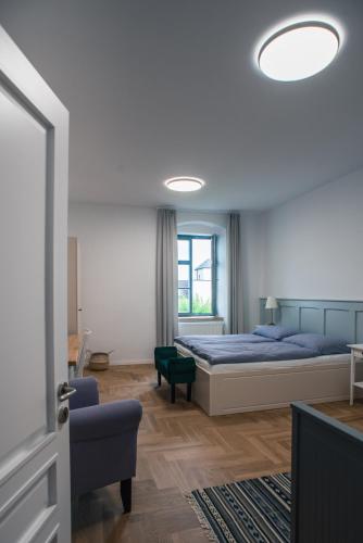 a bedroom with a bed and a large window at Penzion Masarykova 37 Hluboká nad Vltavou in Hluboká nad Vltavou