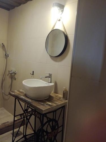 a bathroom with a white sink and a mirror at Seosko turističko domacinstvo Imunsan in Niš