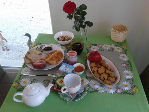 a table with breakfast foods and a teapot and cups at B&B Volver in Peschici