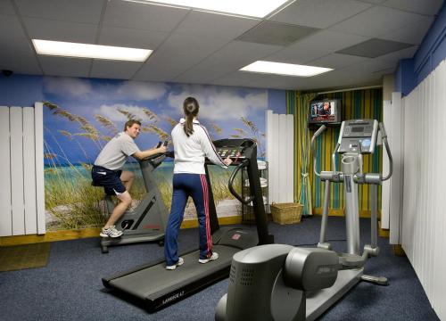 a man and a woman on a treadmill in a gym at Carolina Winds in Myrtle Beach