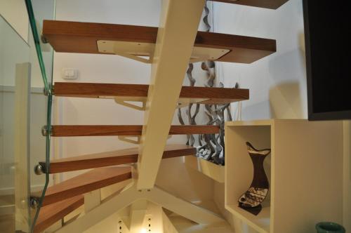 a spiral staircase with wooden treads in a house at Casa Calle Pescheria in Grado