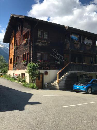 a blue car parked in front of a building at Studio Clausen Kurt in Ernen
