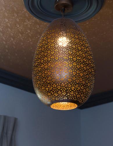 a gold chandelier is hanging from a ceiling at McGettigan's Townhouse - Olives & Figs Bistro in Dublin