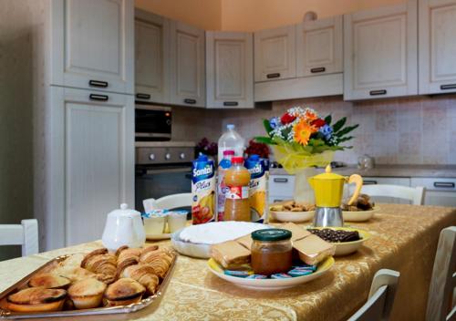a kitchen with a table with bread and food on it at Aura Solis B&B in Leuca