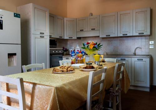 a kitchen with a table with food on it at Aura Solis B&B in Leuca