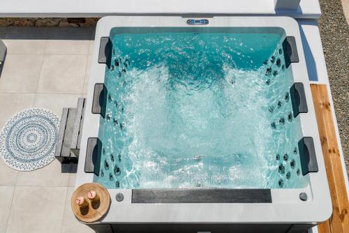 a swimming pool on the floor of a house at Aelion Villa in Vari