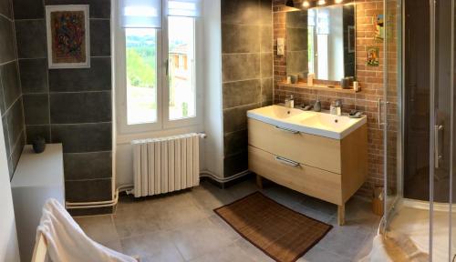 a bathroom with a sink and a mirror at La Cordillière in Laveraët
