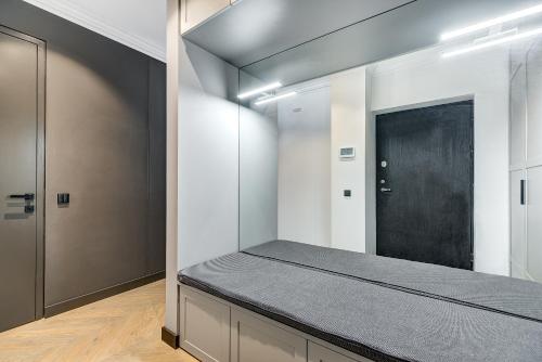 a room with a bed with a black door at HaPPy Inn Presidential, Self check-in, Parking in the underground garage in Vilnius