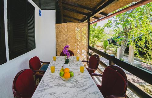 a table with a bowl of fruit on a balcony at Serenity by the Sea #1 - private terrace in Vrsi