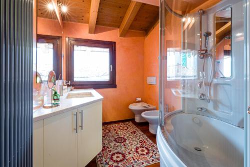 a bathroom with a tub and a sink and a toilet at Sentirsi a Casa in Boario Terme