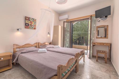 A bed or beds in a room at Andreas Apartments