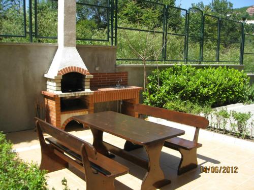 a patio with a table and a pizza oven at Villa Allegra in Kavarna