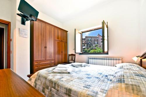 a bedroom with a bed with a dresser and a window at Donna Rachele in Agerola