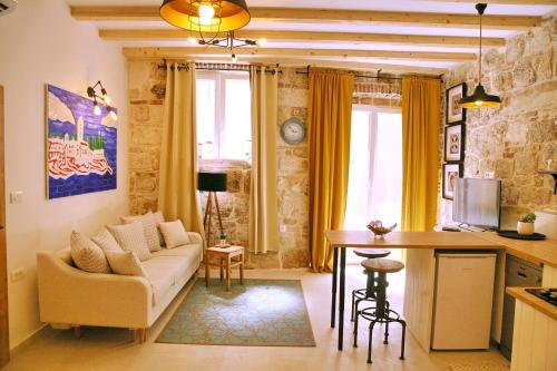 a living room with a couch and a table at House Bava in Vis