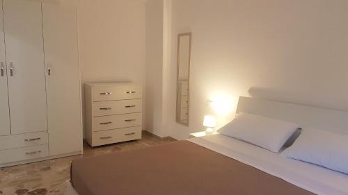 a bedroom with a bed and a dresser and a mirror at Clambè in Palermo