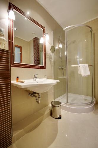 a bathroom with a sink and a shower at Elizabeth Hotel in Gyula