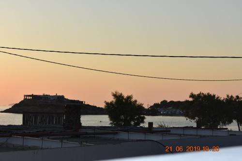 a view of a building on an island in the water at Infinity Apartments in Naxos Chora
