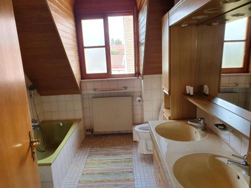a bathroom with a sink and a tub and a toilet at Villa Blue in Nördlingen