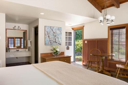 a bedroom with a large bed and a table at The La Conner Inn in La Conner