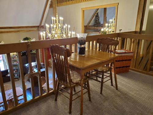 a dining room table with two chairs and a mirror at The Barn Inn Bed and Breakfast in Millersburg