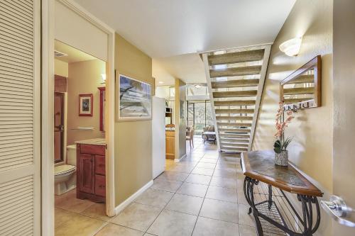 a kitchen with a staircase and a table in a room at Paniolo Condo in Kahuku