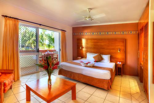 1 dormitorio con cama y ventana grande en Bedarra Beach Inn en Korotogo