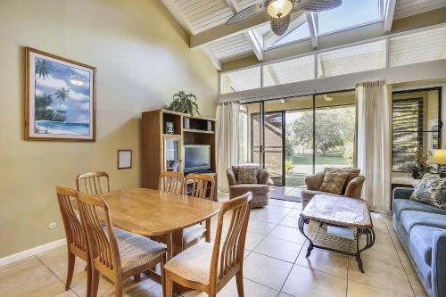 a dining room with a table and chairs and a couch at Paniolo Condo in Kahuku