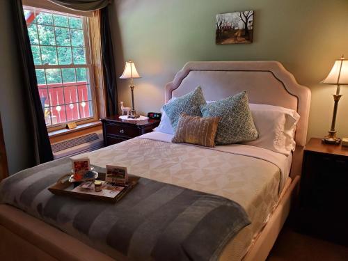 a bedroom with a large bed with a tray on it at The Barn Inn Bed and Breakfast in Millersburg