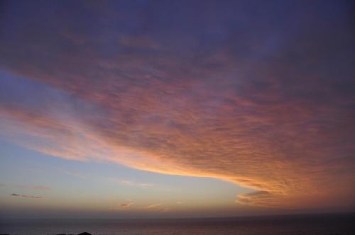 a cloudy sky over the ocean at sunset at Boutique Hotel Mamabels in Mojácar