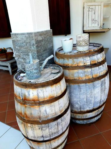 two large wooden barrels sitting next to each other at Grotta dei Puntali B&B in Carini