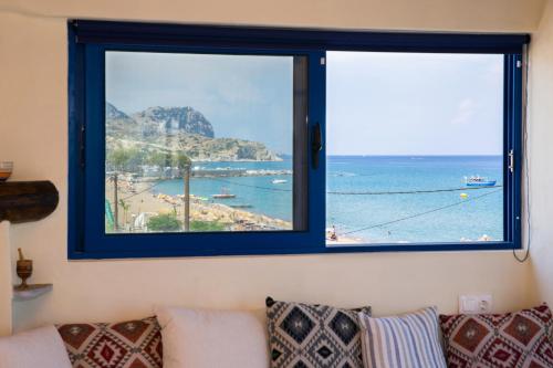 a view of the beach from a window at Apágkio Filoxenia in Archangelos