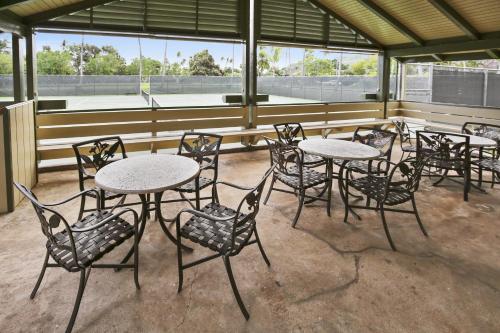 a group of tables and chairs in a room at Anthurium Condo in Kahuku