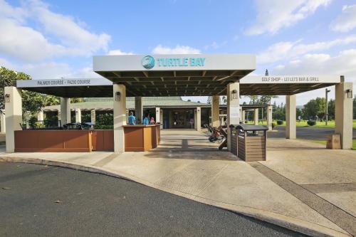 a gas station with a sign that reads time city at Anthurium Condo in Kahuku