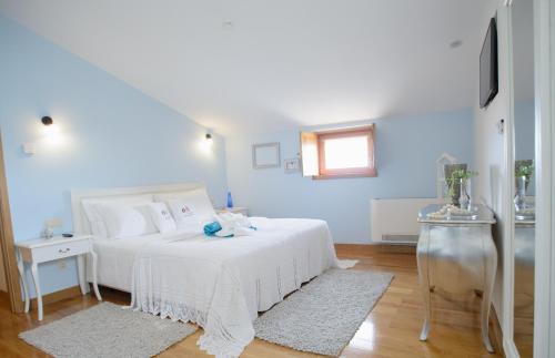 Ένα ή περισσότερα κρεβάτια σε δωμάτιο στο Casa da Amendoeira