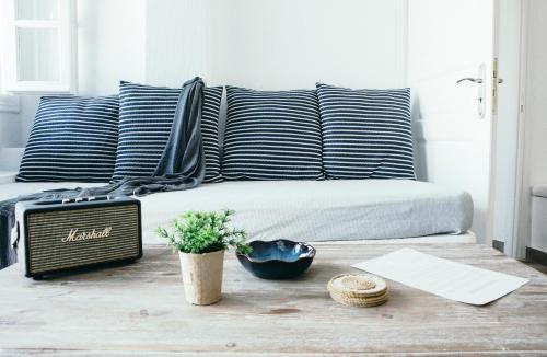 a bedroom with a bed with blue and white pillows at Oia's Secret in Oia