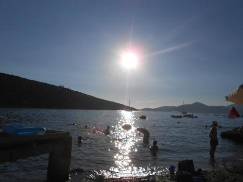 a group of people in the water at a beach at Apartments Vila Lazarevic in Tivat