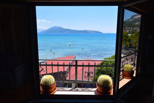 a window view of the ocean from a balcony at Apartments Grifone Lux in Herceg-Novi