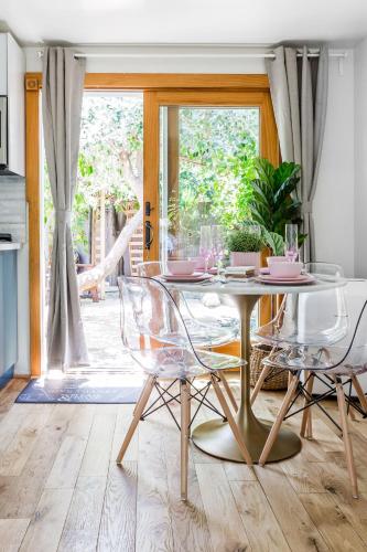 a dining room with a glass table and two chairs at Charming 1-Bedroom Home near Downtown Culver in Los Angeles
