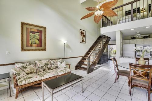 a living room with a couch and a staircase at Pupukea Condo in Kahuku
