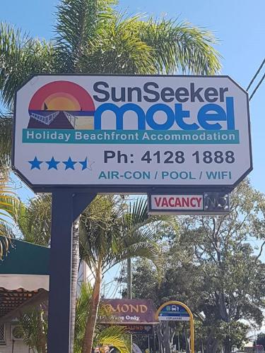 a sign for a sunvisor sign for a holiday beachfront accommodation at Sunseeker Motel in Hervey Bay